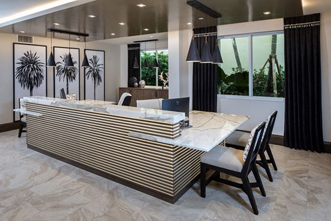 a large kitchen with a large island and a table with chairs