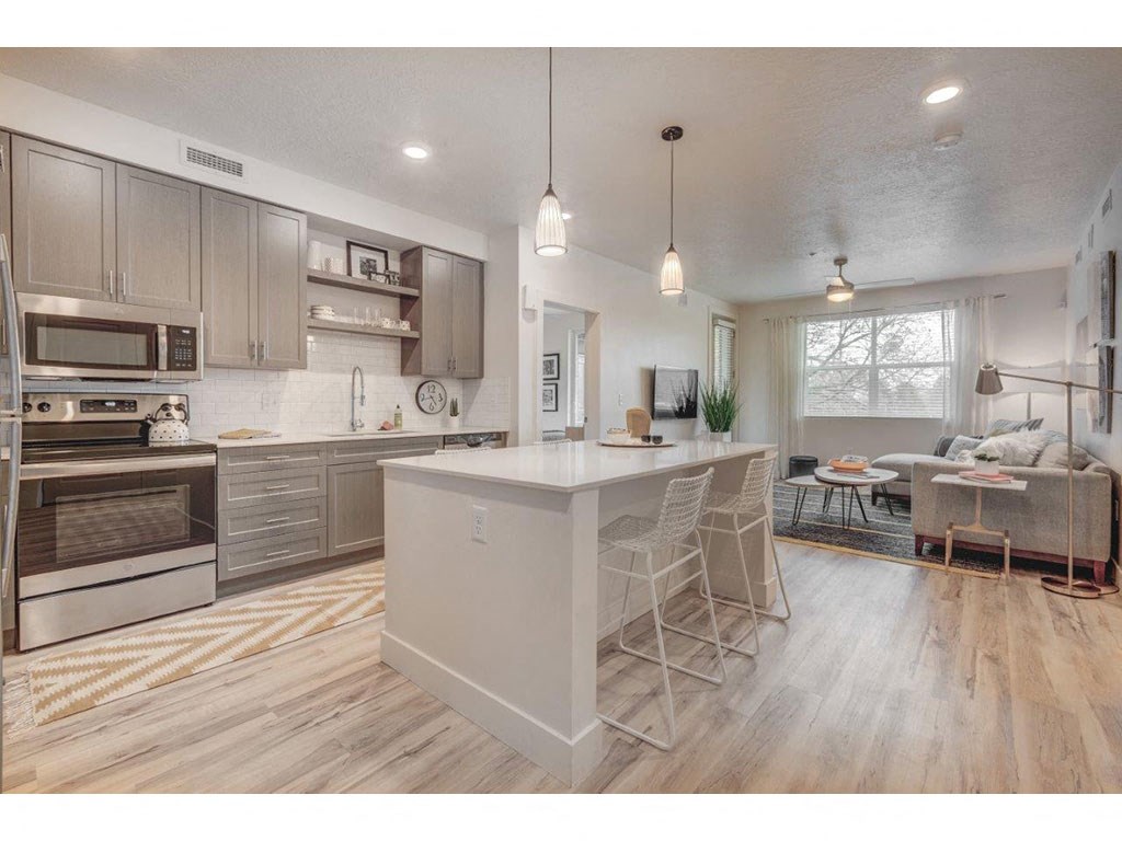 a large kitchen with a center island with two stools