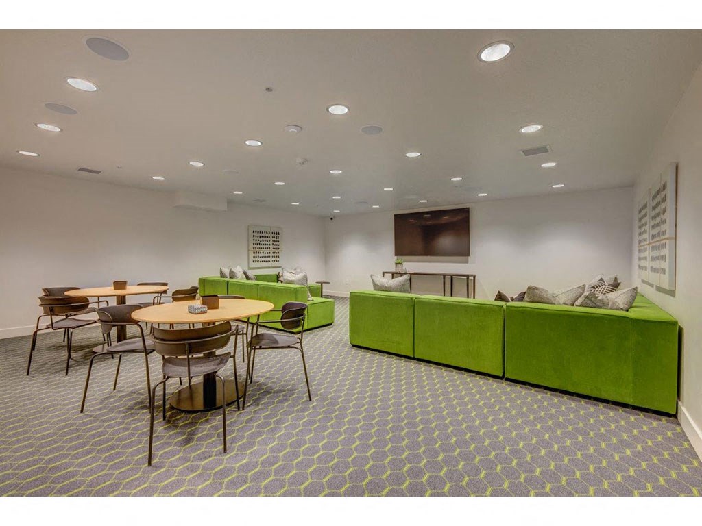 a living room with tables and chairs and a television