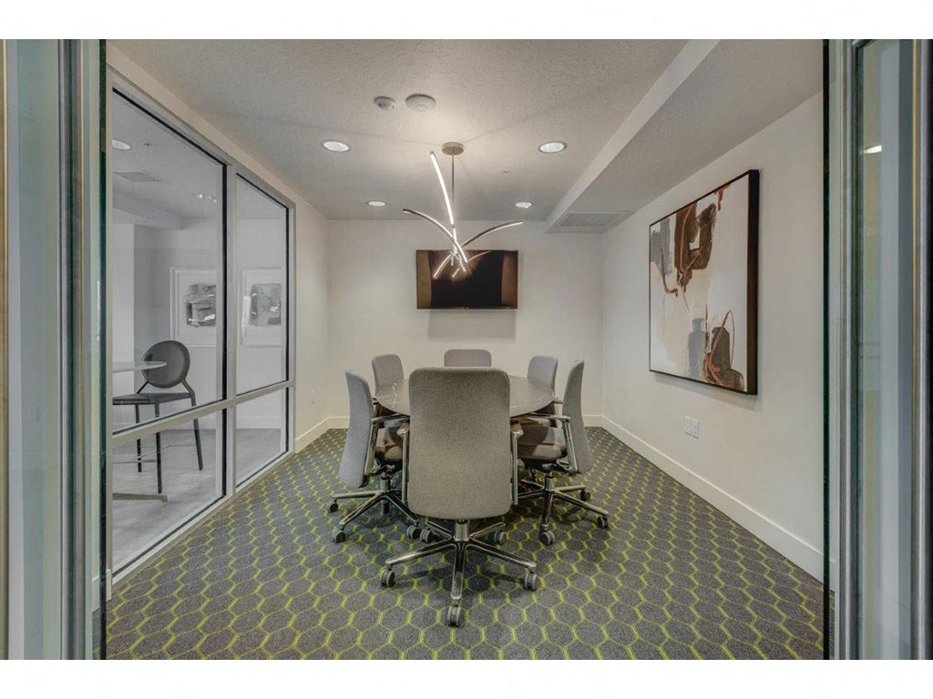 a conference room with a table and chairs
