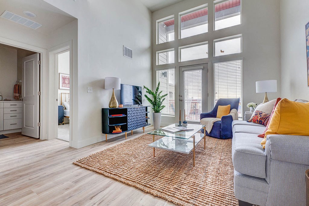 a living room with a couch and a coffee table and a fireplace