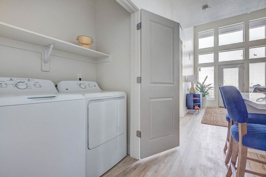 a washer and dryer in a laundry room next to a dining room table
