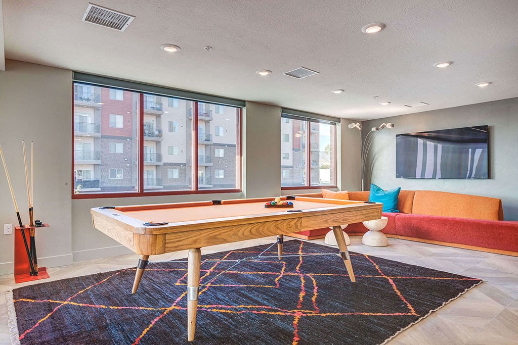 a game room with a pool table and a couch