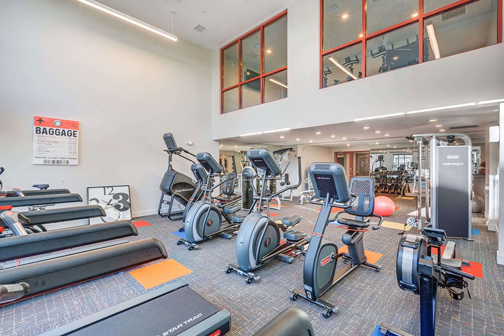 a gym with cardio equipment and weights in a building