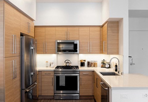 a kitchen with stainless steel appliances and wooden cabinets