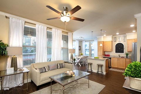 a living room with a couch and a ceiling fan