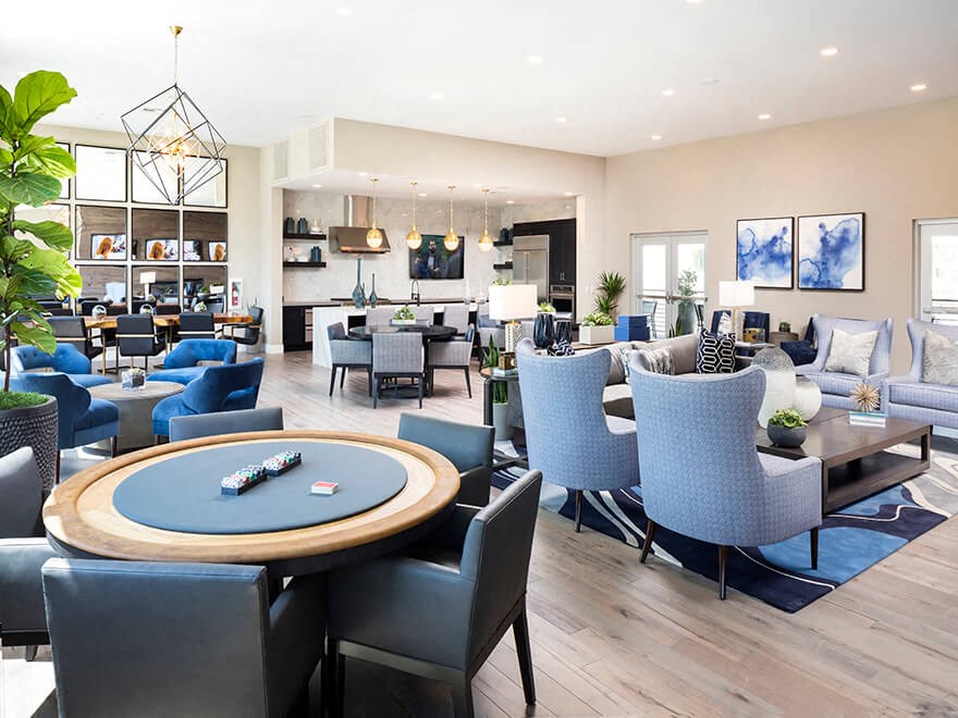 a clubhouse with tables and chairs and a pool table