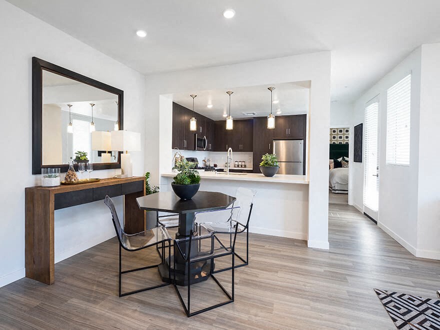 a kitchen and dining room with a table and chairs