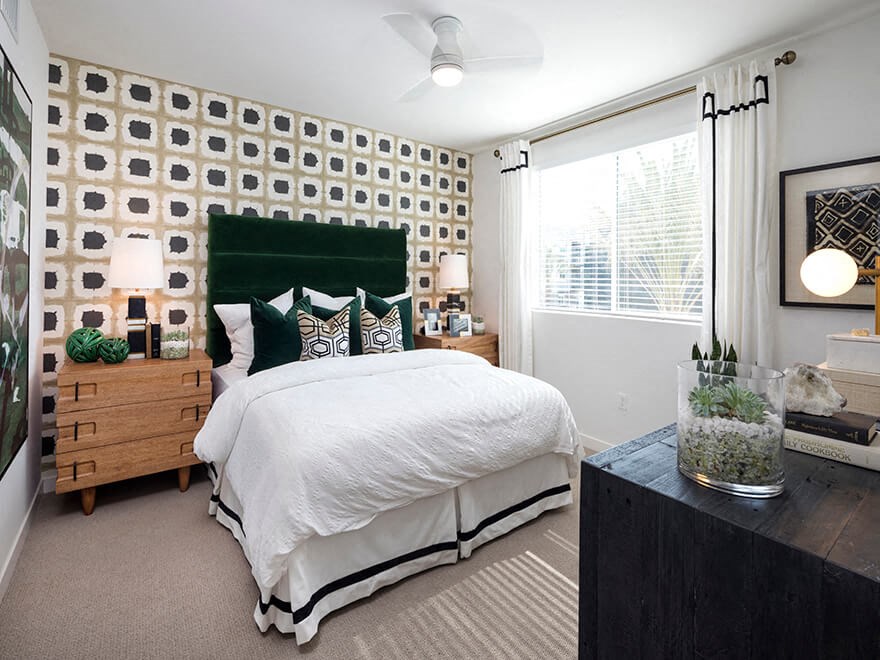 a bedroom with a white bed and a green headboard