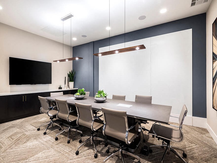 a conference room with a long table and chairs