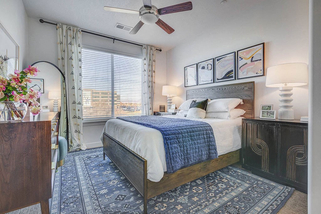 a bedroom with a bed and a ceiling fan