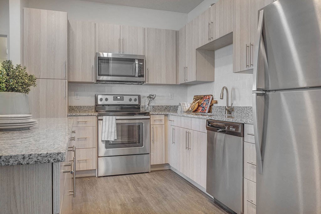 a kitchen with stainless steel appliances and white cabinets