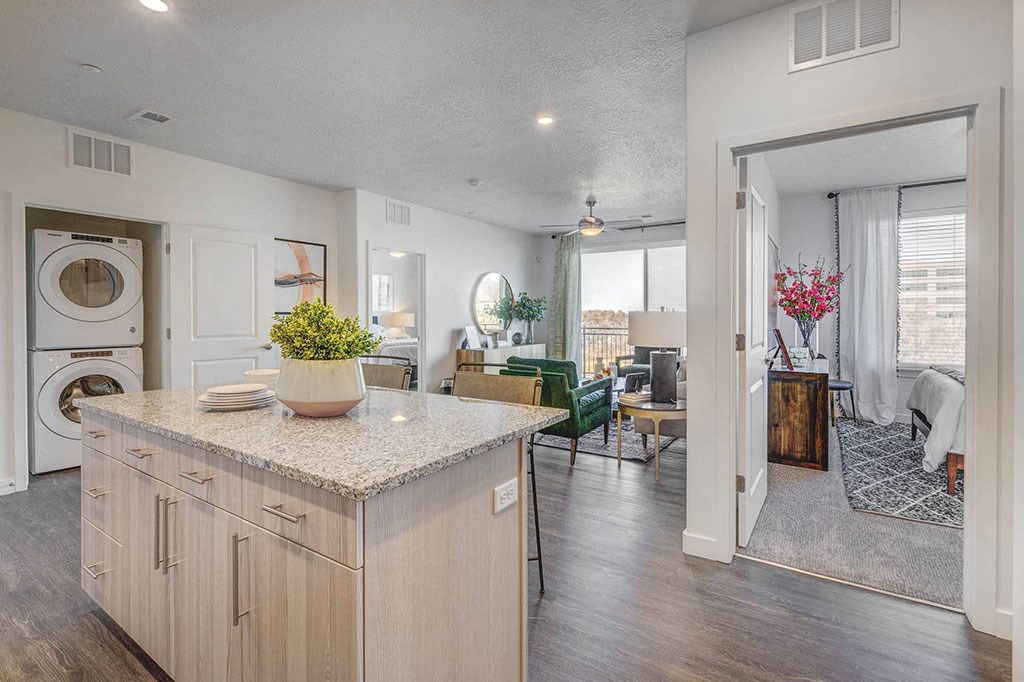 a kitchen with a view of a living room and a washing machine