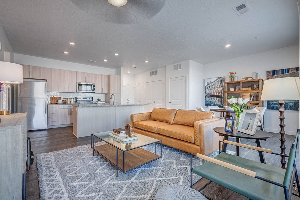 a living room and kitchen with a couch and a table