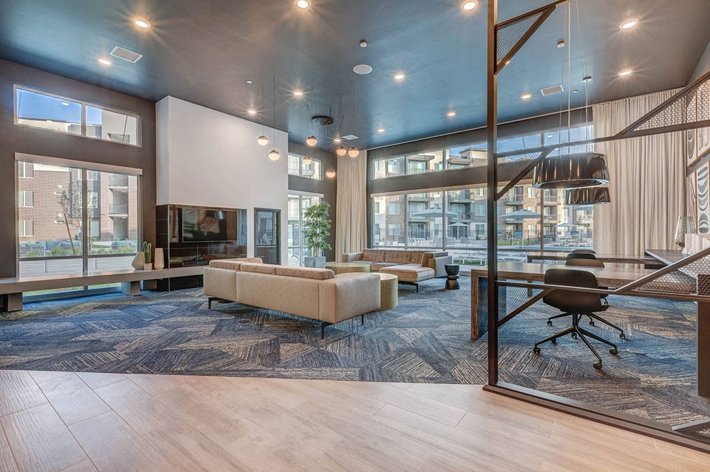 a living room with couches and a table with a chair