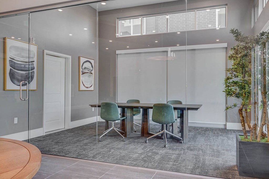 a conference room with a table and chairs