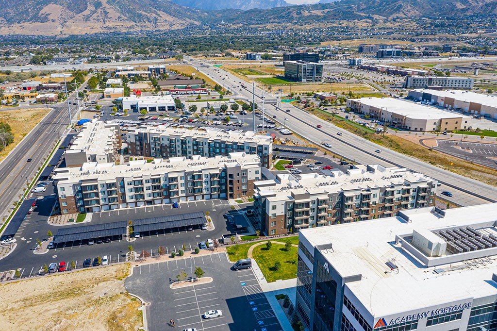 an aerial view of a city with buildings and highways