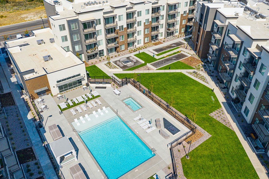 an aerial view of an apartment building and a swimming pool