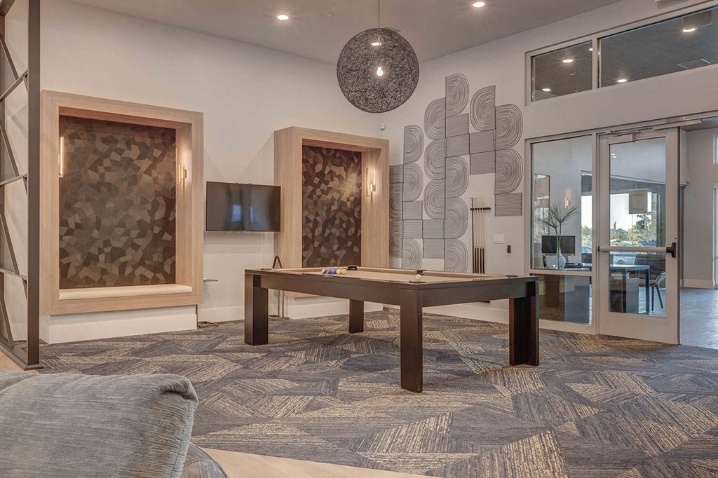 a games room with a pool table