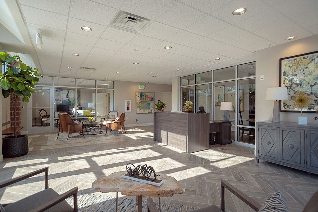 a lobby with a reception desk and a table