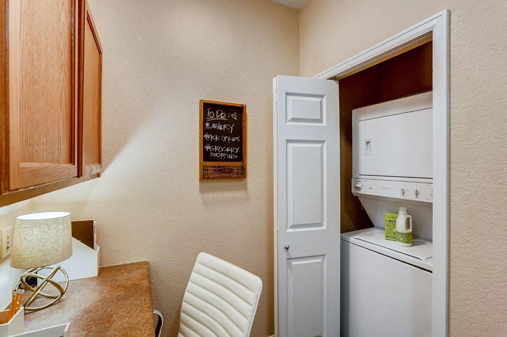 a kitchen with a dining table and a white refrigerator
