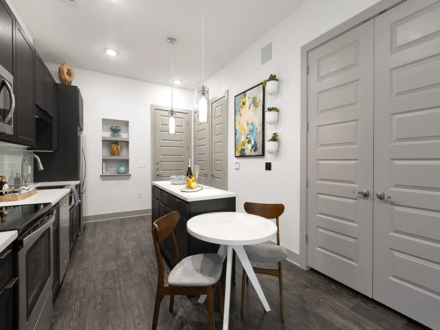 a kitchen and dining room with a table and chairs