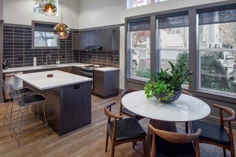 a kitchen with an island and a table with chairs