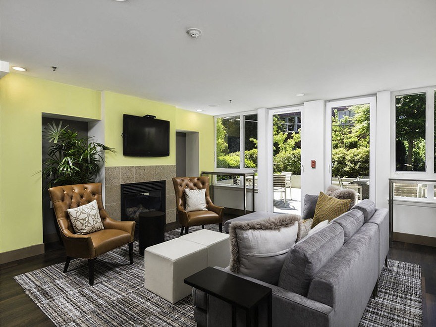 Clubhouse with lounge seating, wall tv and fireplace at Axis, Washington, 98109