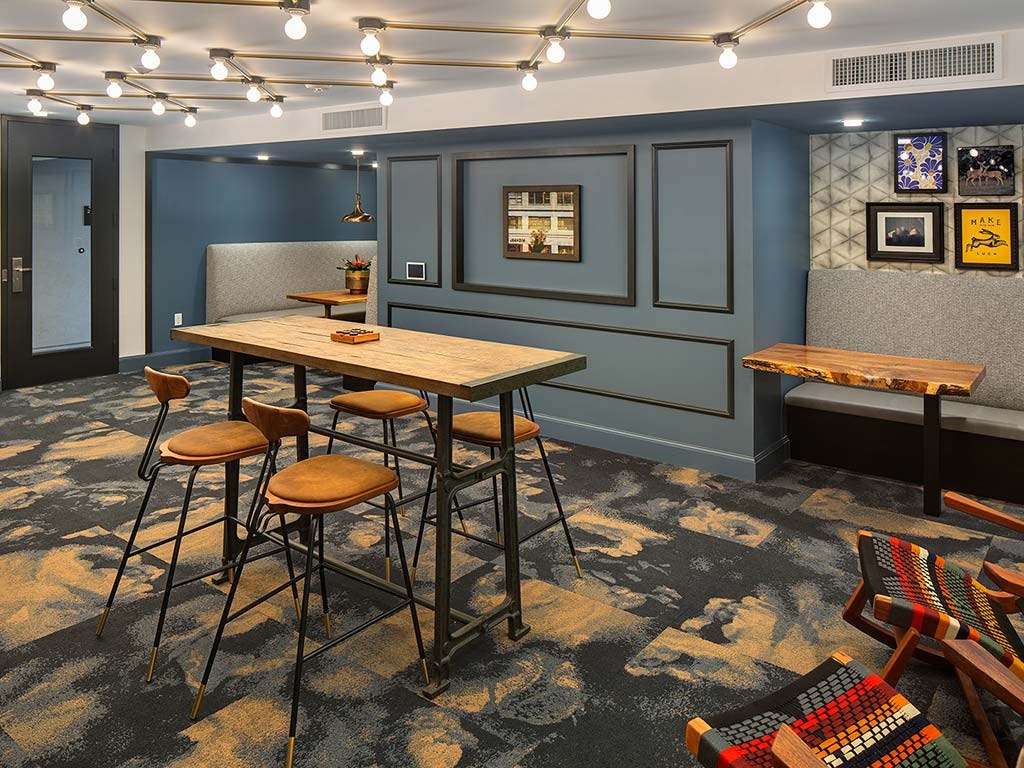 a communal table in a room with bar stools