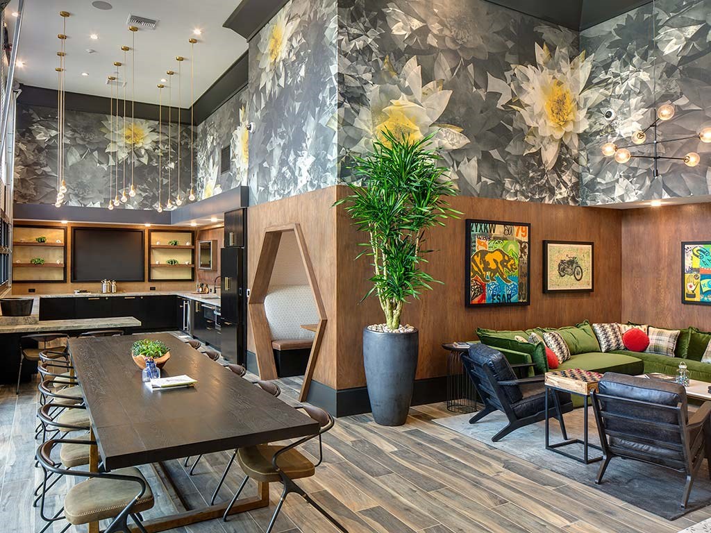 the lobby of a hotel with a table and chairs