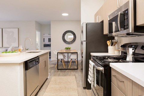 a kitchen with stainless steel appliances and white counters