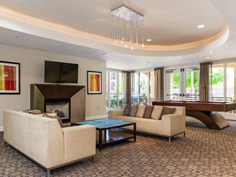 the living room has a fireplace and a pool table