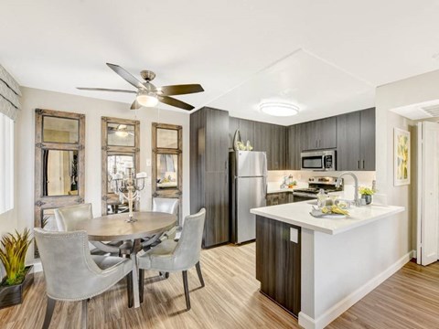 a kitchen and dining room with a table and chairs