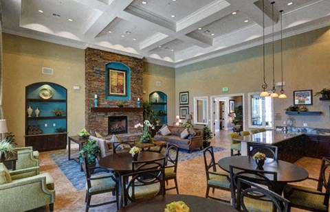 a living room with a table and chairs and a fireplace