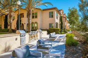Patio with chairs and a grill in front of a building at Ocean Air, San Diego, 92130