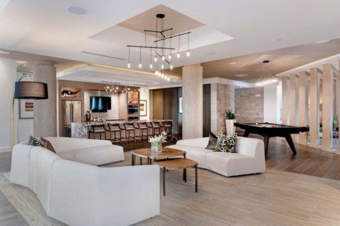 a living room with couches and a pool table