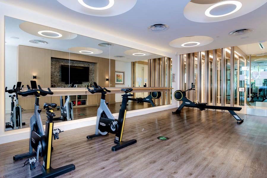 Fitness center with tablet-integrated cardio machines at Vora Mission Valley, California