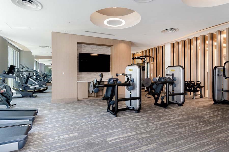 On-site 24-hour fitness center with tablet-integrated cardio machines at Vora Mission Valley, San Diego