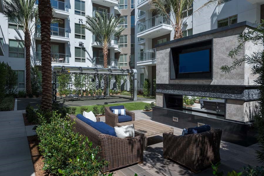 Open-air Loggia with large screen TV's and cozy seating area at Vora Mission Valley, San Diego, CA, 92120