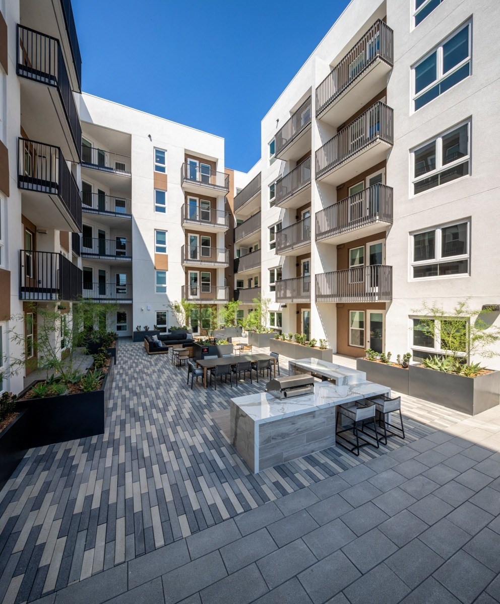 A modern apartment complex with a communal courtyard.