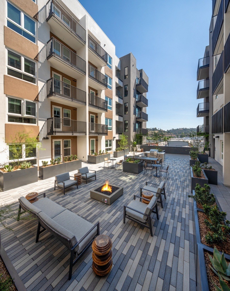 A modern apartment complex with a shared outdoor patio area.
