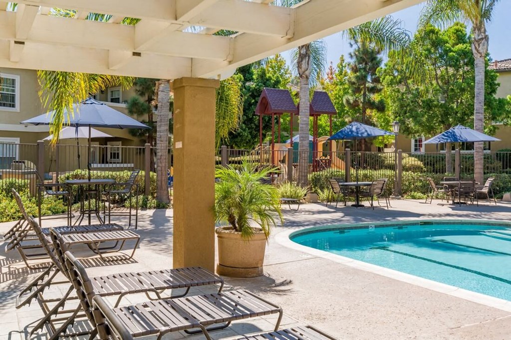 Swimming Pool With Lounge Chairs at The Landing at Ocean View Hills Apartments