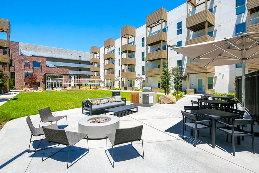 Outdoor space with volleyball area and grill