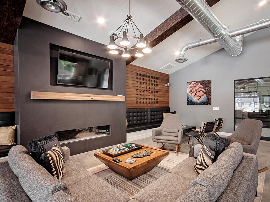 Clubhouse lounge seating, fireplace and wall tv close up