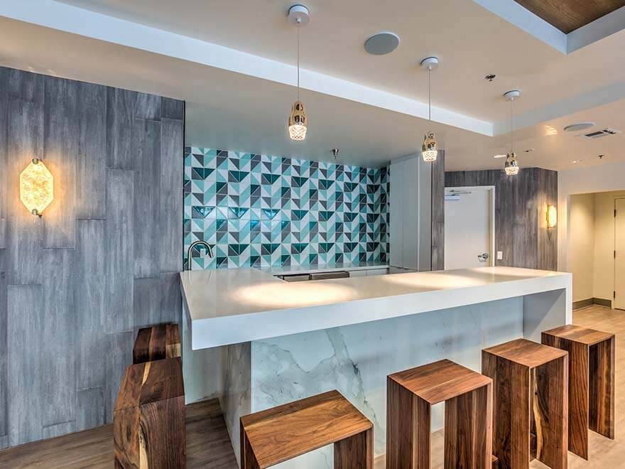a kitchen with a counter top and some stools
