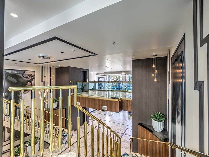 a large room with a staircase and a bar in it