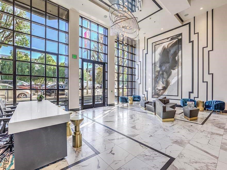 a large lobby with large windows and a marble floor