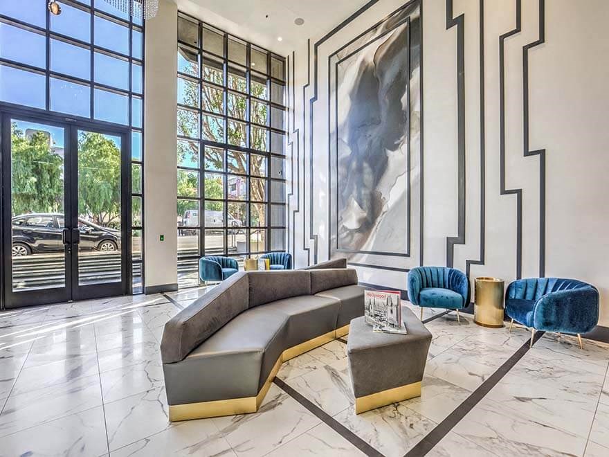 a living room with a couch and a large painting on the wall