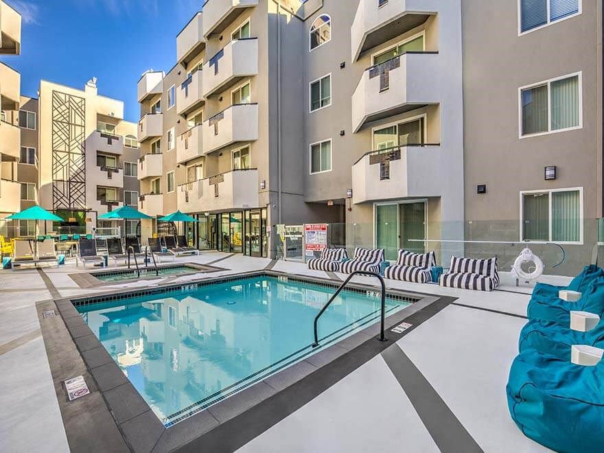 a swimming pool in front of an apartment building