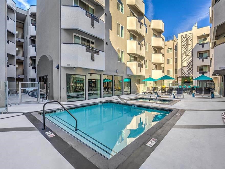 a swimming pool in the middle of an apartment building